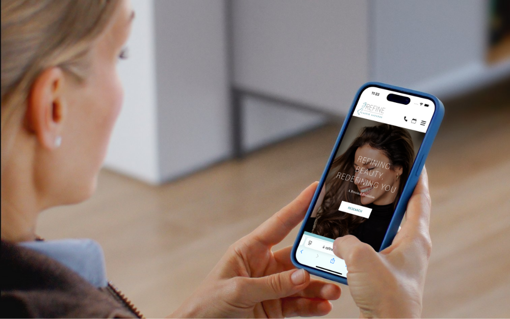 Refine_mobile_mockup_woman_holding_phone Refine_mobile_mockup_woman_holding_phone